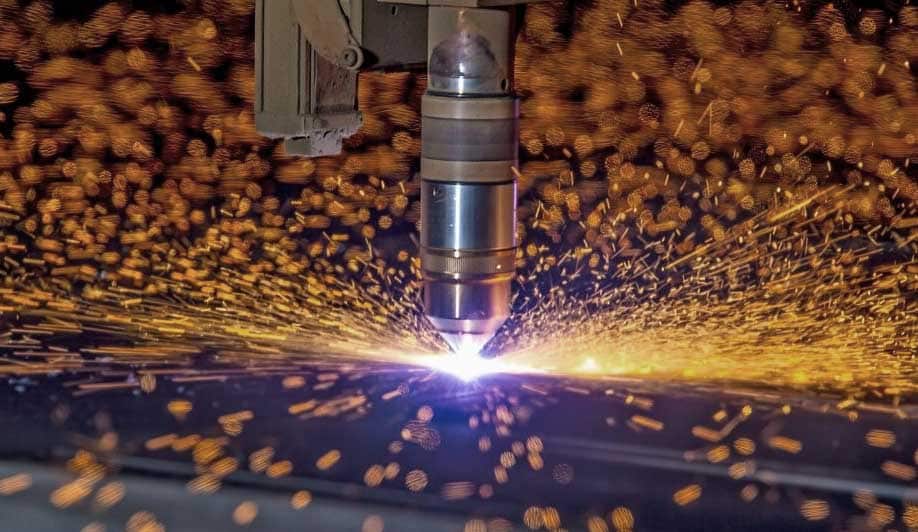 Plasma cutting a metal sheet.